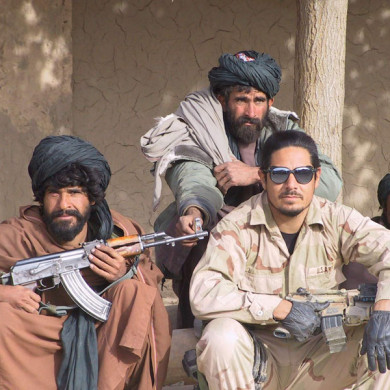Intelligence Sergeant Gilbert “Mag” Magallanes with Pashtun guerrillas in Tarin Kowt, November 2001. Photo: ODA 574 archives.